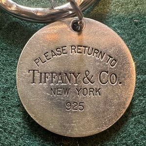 Tiffany & Co. round silver Return to Tiffany pendant charm. Charm only.
